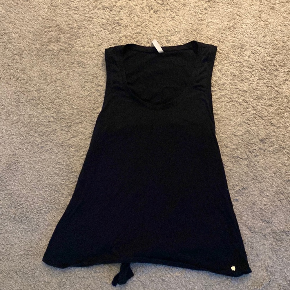 Fabletics tank top on black. Open on the back